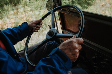 man driving am old car