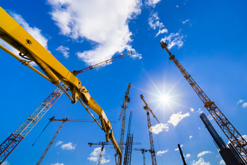 Construction site  with cranes on a sunny day.