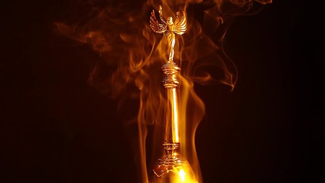 gold angel statue smoke dark background hd footage 