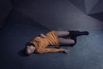  Lifeless unconscious woman lying on a factory floor