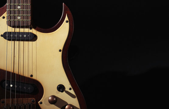 Electric guitar on black background. Space for text