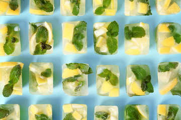 Flat lay composition with lemon and mint ice cubes on color background