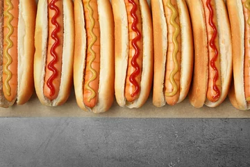 Foto op Canvas Tasty fresh hot dogs on grey background, top view © New Africa