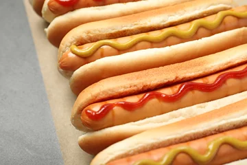 Foto op Plexiglas Tasty fresh hot dogs on grey table, closeup © New Africa