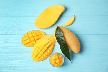 Flat lay composition with mango on wooden background