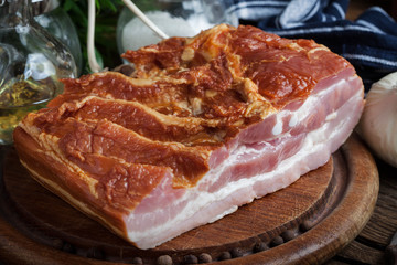 Raw bacon on a chopping board.