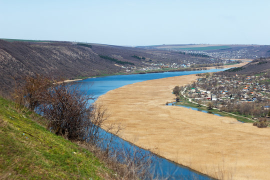 River flowing between hills and villages in rural areas