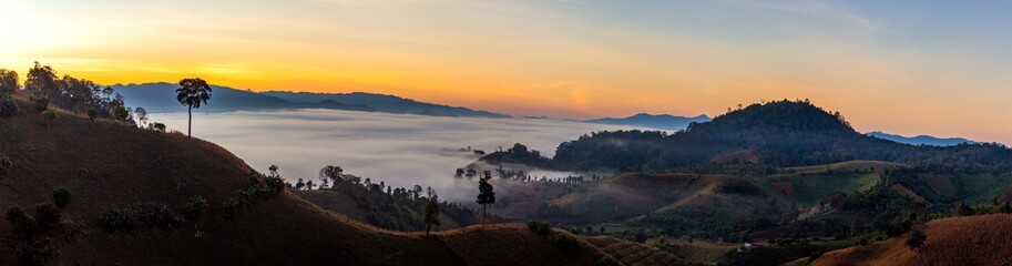 Mountain and foggy at morning time with orange sky, beautiful landscape in the thailand