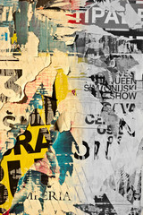 Fototapeta premium Old grunge ripped torn vintage collage street posters creased crumpled paper surface placard texture background backdrop / Selective color