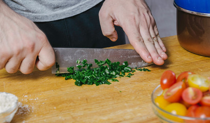 Chef's hands cutting mangold leaves