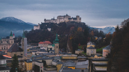 Castle and fortress Hohensalzburg on mountain Festung in Salzburg city, Austria. Moody dark cityscape late autumn.