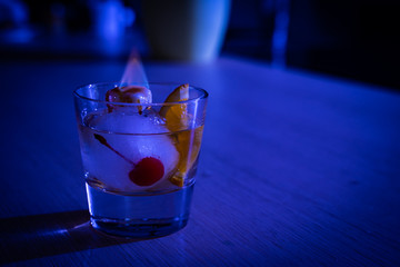 Homemade special interpretation of classic Old Fashioned Cocktail, made in an Ice Ball with orange and cinnamon flavored sugar burning on top