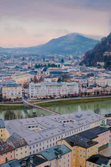 Salzburg cityscape woth old town streets, river Salzach and mountains om background of morning sky, view above