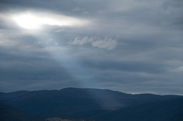 Ray of a sunlight piercing through the clouds