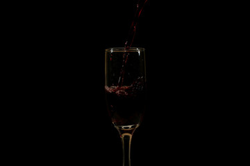 Pouring delicious red wine into glass