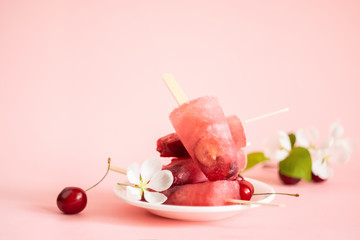 Refreshing fresh-cherry berry ice cream on a white plate on a pink isolated background. Front view horizontal frame. Copy space. Place for design or text.