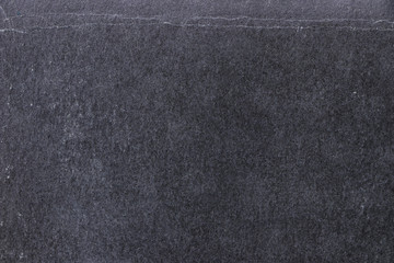 Blank black background. Texture of old black shabby paper and cardboard surface. Vintage dark backdrop with space for text or image.