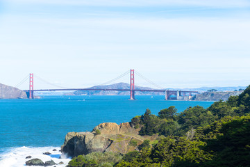 The view of golden gate bridge in Lands end at San Francisco- San Francisco. summer , cloud , rock , sea, plant.