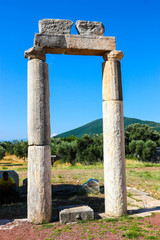Fototapeta na wymiar Ruins of ancient greek temple against a blue sky, ancient Messini, Greece