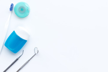 Tooth care with toothbrush, dental floss and dentist instruments. Set of cleaning products for teeth on white background top view mockup