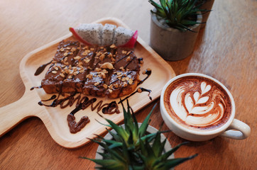 Hot Coffee on wooden table with chocolat on bread