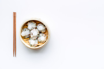 Dinner in Chinese restaurant with dim sum, sticks on white background top view space for text