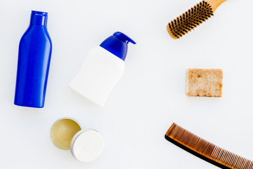 Instruments of male hairdresser with shampoo and comb in barbershop top view on white background mock up