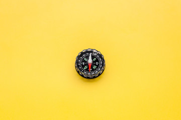 Direction concept with compass on yellow background top view mockup