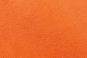 Texture of genuine leather orange color. Material of animal origin. Close-up.