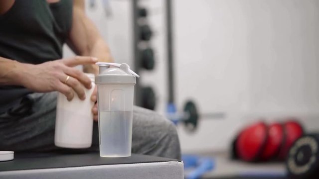 close up. shaker with water for the dilution of amino acids. athlete prepares vitamin cocktail