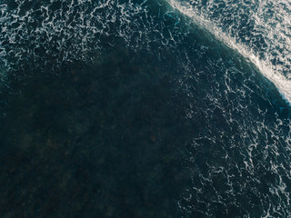 Aerial view beautiful of sea waves from drone. Stock image picture of blue color ocean water, wave, sea surface. Top view on turquoise waves, clear water surface texture. Top view, amazing nature