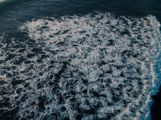 Sea aerial view, top view, amazing nature background. Blue color of the water and beautiful bright. Azure beach with turquoise waves and clear water of ocean on sunny day. Sea view from flying drone