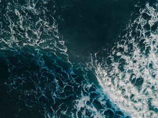 Aerial view beautiful of sea waves from drone. Stock image of blue color of ocean water, sea surface. Top view on turquoise waves, clear water surface texture.  Top view, amazing nature background