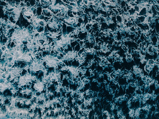 Aerial view beautiful of sea waves from drone. Stock image of blue color of ocean water, sea surface. Top view on turquoise waves, clear water surface texture.  Top view, amazing nature background