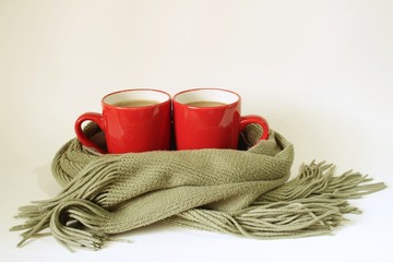 Scarf wrap around two cups of coffee, to keep warming.