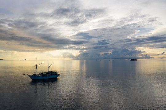 Aerial of Tranquil Sunrise and Sail Boat in Raja Ampat