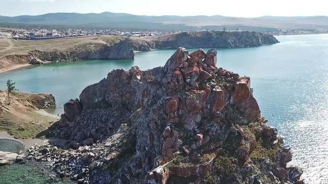Tranquil Aerial View of the Baikal Bay Shamanka. White ship in calm bay at great lake. Olkhon Island, Baikal. Drone footage.