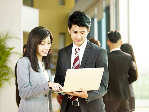 young asian business man and woman working together in office
