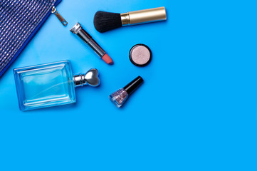 Cosmetic bag cosmetics perfume on blue background