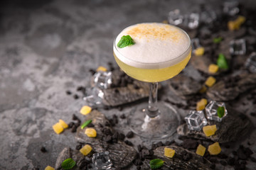 Alcoholic or non-alcoholic cocktail with lemon citrus and ginger with added liqueur, vodka,...