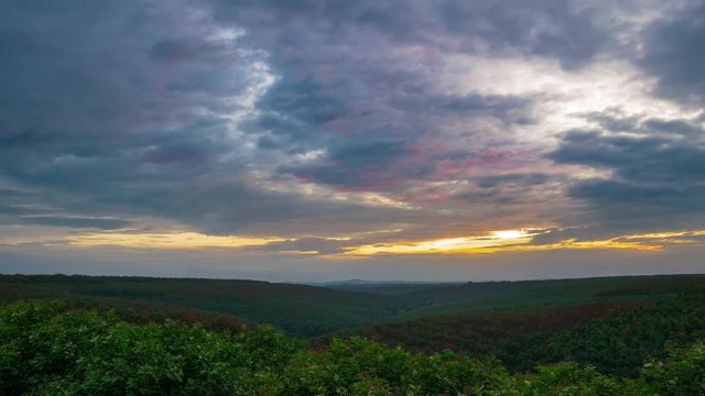 Time lapse: sunset over rubber cashew trees industrial plantation agriculture in Banlung, Ratanakiri, East Cambodia