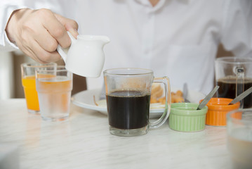 Business man eat the American breakfast set in a hotel - people take a breakfast in hotel concept