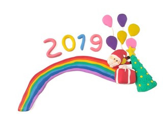 Obraz na płótnie Canvas Beautiful rainbow decorated cute Santa Claus with snow Christmas tree number 2019 new year red gift box and colorful balloon are made from plasticine clay on white background, cute festival dough