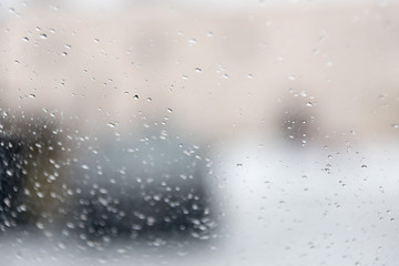 Drops on glass, a view from within of the city
