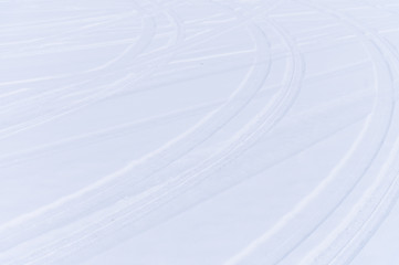 Traces of intersecting arcs of automobile tires in fresh snow