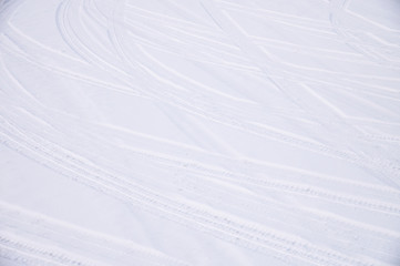 Traces of intersecting arcs of automobile tires in fresh snow