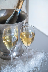 Celebration concept: two glasses of champagne and bottle in the bucket