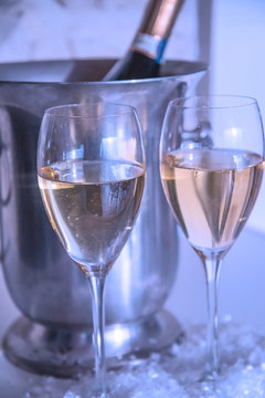 Two glasses of champagne and bottle in the bucket, vertical picture