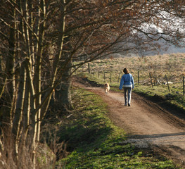 Obraz premium Girl walking the dog in a park in Denmark
