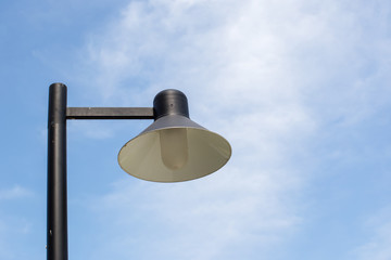 Close up vintage lamp and pole in the garden park and blue sky background. Electrical light in the night. image for background, wallpaper and objects.
